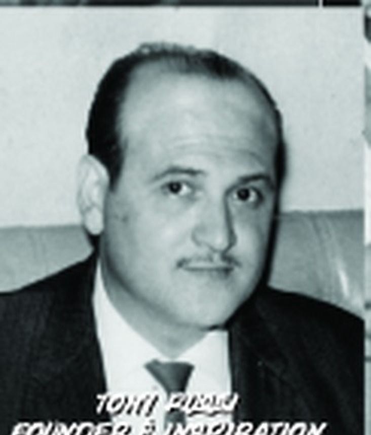 Portrait of Tony Russi in a suit and tie, co-founder of Pepe's.
