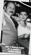 Joe and Maria Russi dressed formally at a family wedding, circa 1960s.